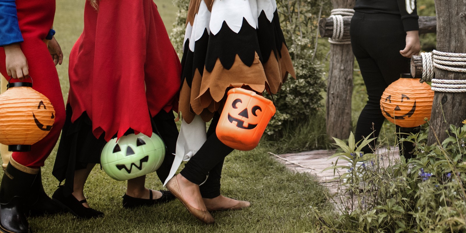 Children trick or treating with pumpkin baskets