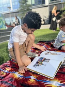 Wise Wonder student reading outside on a summer day